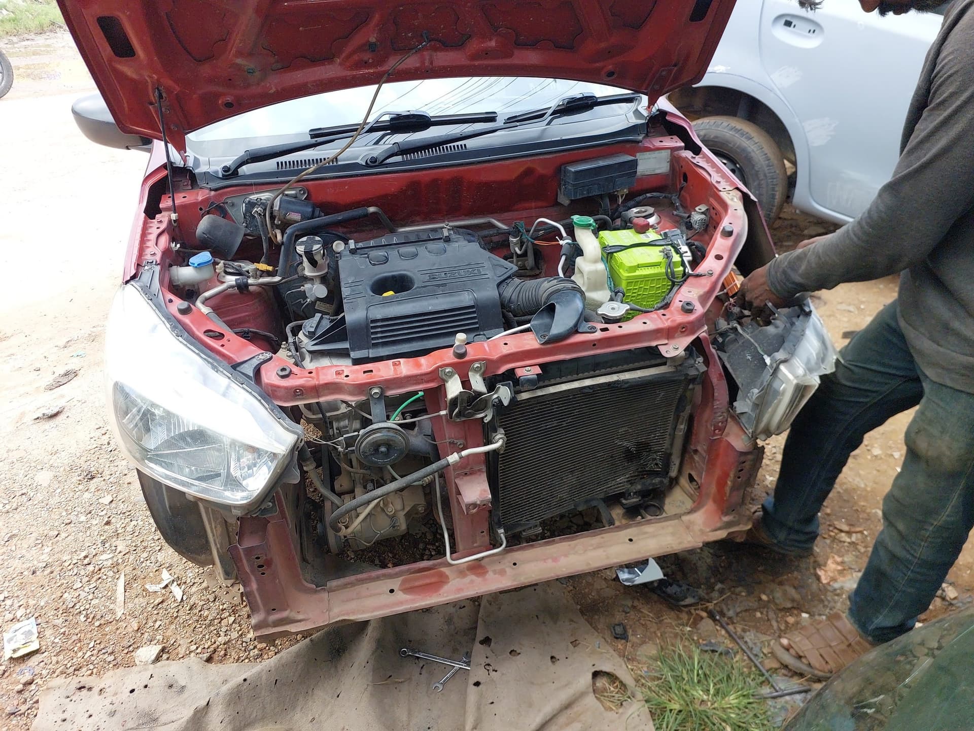 Front-end tinkering with bumper removed on a red car